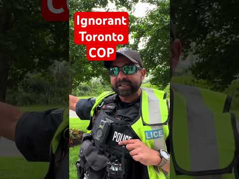 Toronto Cop Looks Stupid Telling Me It’s a Scene Meanwhile There’s a Lady Gardening In His Scene 😂