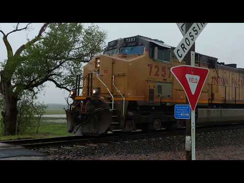 Union Pacific 7257  grain train with BNSF 5949 southbound in the rain near Loveland , Iowa