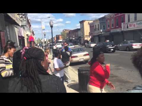 Church Members Sing In Street In Baltimore Riot Aftermath