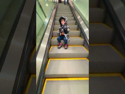 Cute baby boy😋 relaxing on #escalator and eating lollipop🍭😀😍