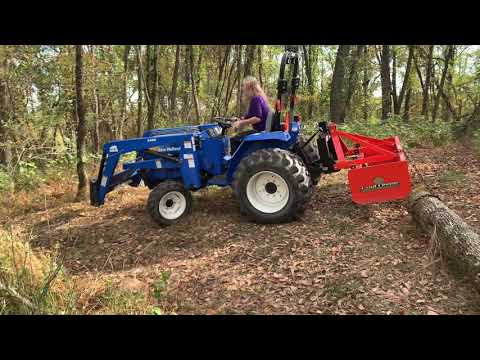 Pulling a log out of the woods with our New Holland!