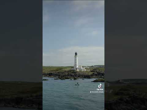 Paddle boarder passing Corsewall Lighthouse #southwestscotland #lighthouse #shorts