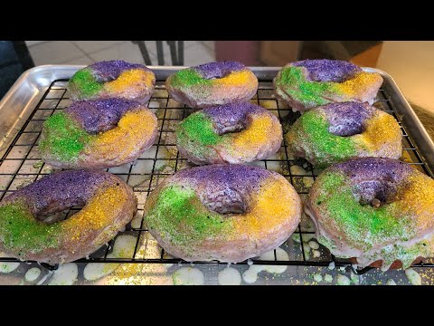 King Cake Doughnuts | A glazed cinnamon infused doughnut with King Cake sugar sprinkles on top