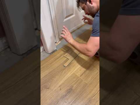 Installing full floor plank underneath door trim. #flooring #installation #floordesign #tools #tips