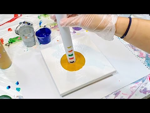 Acrylic pouring: kitchen paper roll tunnel pour on a metallic puddle