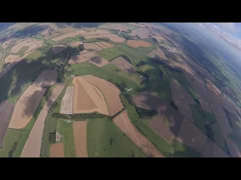 Paragliders and sailplanes flying in harmony