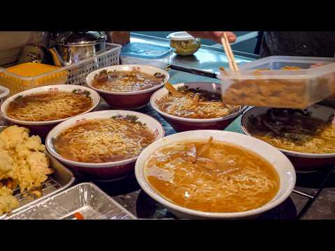 A 78 year old man playing street vendor ramen with his granddaughter.