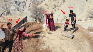 The industrious Ayas family: Fatima and Ayas finishing the roof of the house (Kohrig family)