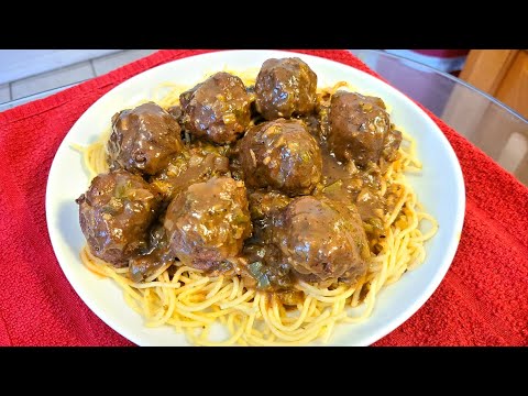 Meatballs smothered in gravy over seasoned spaghetti