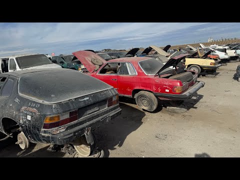 Two Porsche 924’s, one  Mercedes-Benz R107 450SL and one C107 450SLC at Junkyard in California