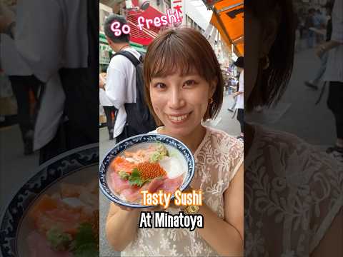 A Japanese girl shares Sushi over rice, Kaisendon / Variety Seafood Bowl at Minatoya in Ueno