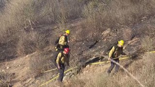 Firefighters stop the Kenneth Fire from spreading in the San Fernando Valley