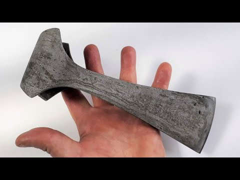 Forging process of the wrought iron medieval AXE. Scrap metal replica.