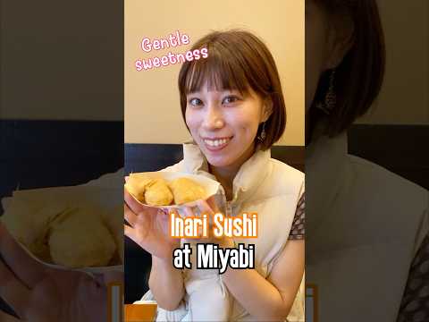 A Japanese girl shares traditional Japanese Food Inari Sushi at Miyabi in Akihabara