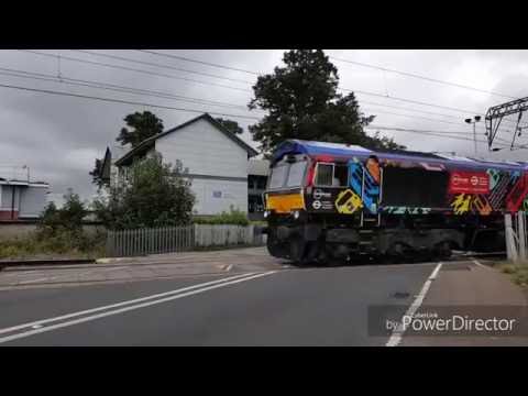 Trains at speed in east anglia freight and passenger trains racing through the station