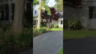 Inviting front entry with dark-toned Town Hall pavers adds visual contrast to surrounding greenery.