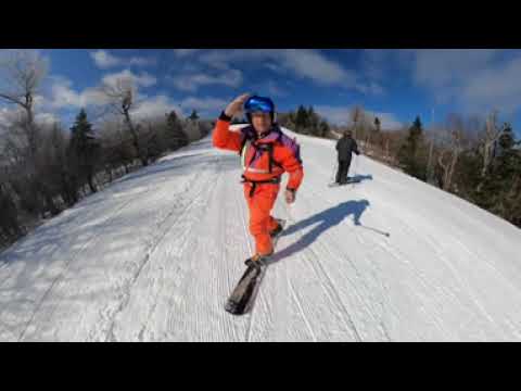 Orange suit snowboarding at Okemo