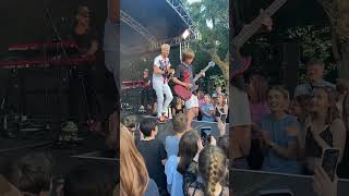 Can't believe this happened! 🤯 10 year old asks band at festival to let him play guitar..