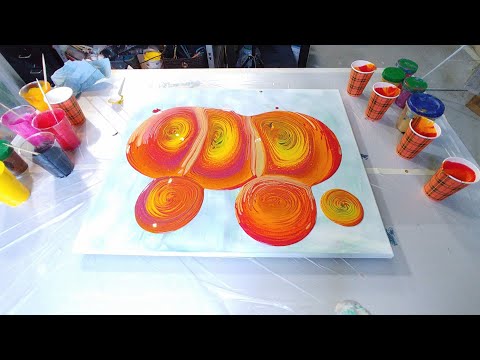 Acrylic pouring: Multi ring pour in scary colours orange, magenta, red and orange