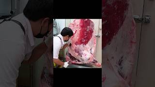 Master of boning beef parts - young butcher